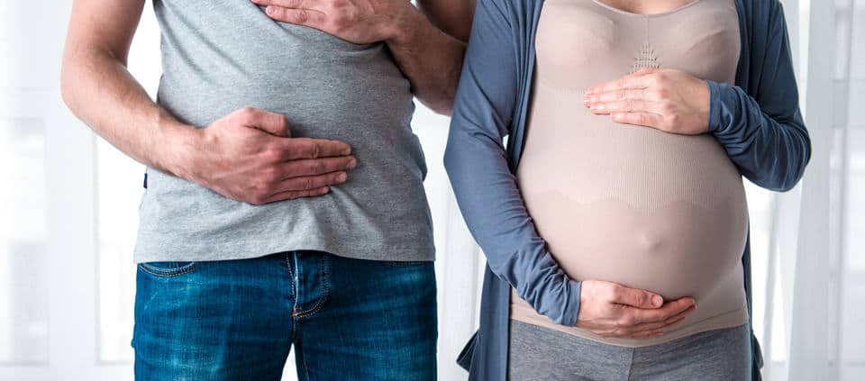 Couvade syndrome, Mom and dad hold belly