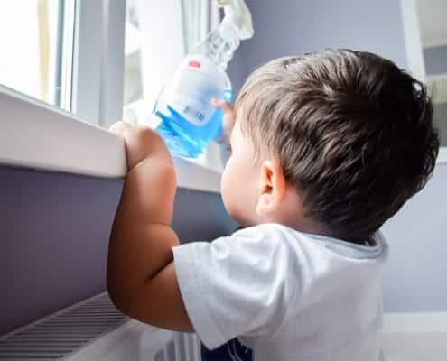 Toddler reaching for cleaning product