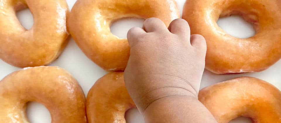Baby reaching for donuts