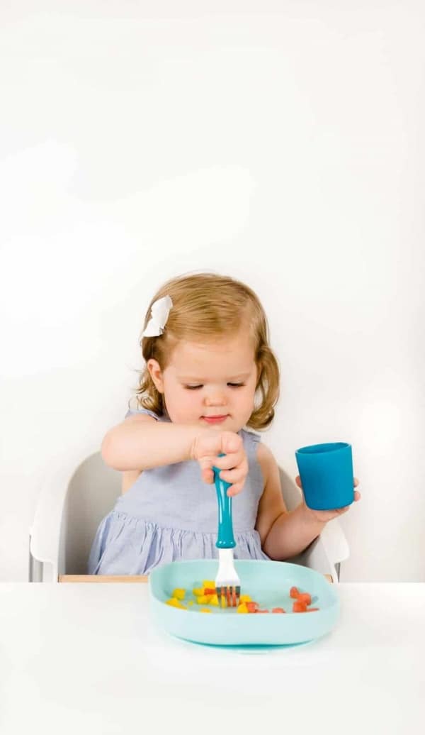 Toddler Drinking From Beaba Silicone Cup Peacock