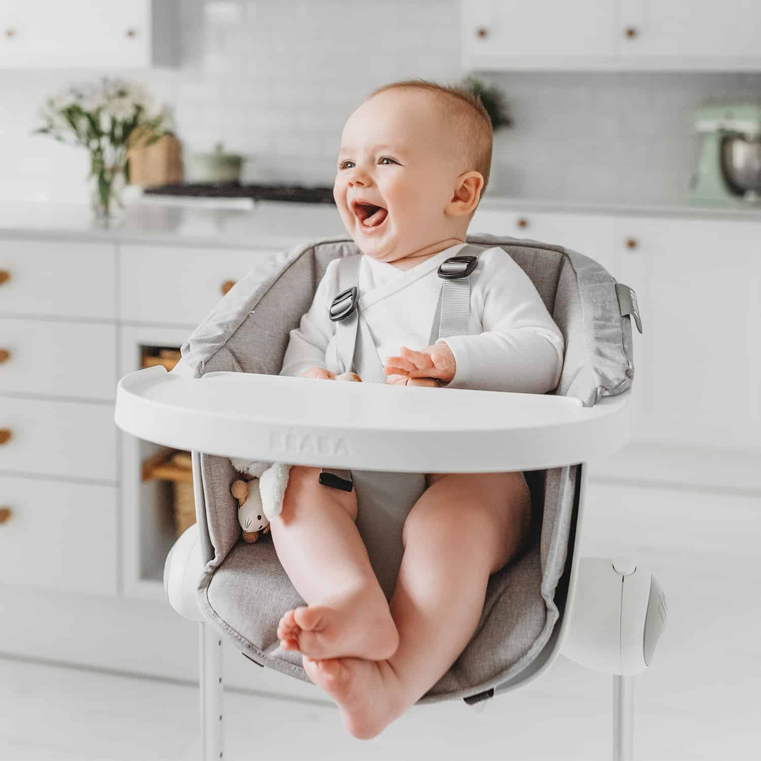 Baby smiling and sitting in BEABA Up & Down High Chair