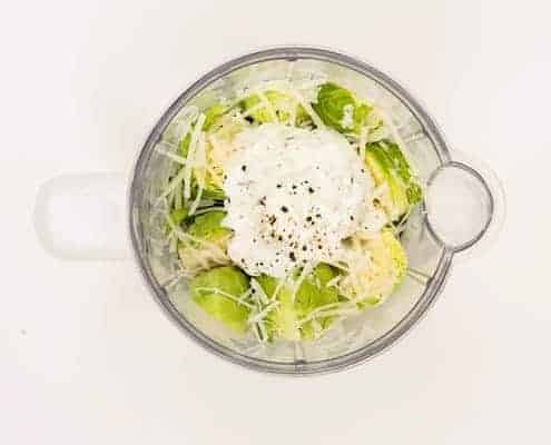 creamy brussel sprouts with parmesan in mixing bowl