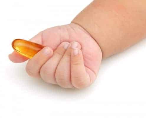 baby hand holding vitamin