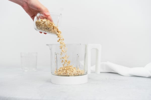 pouring oats into babycook bowl