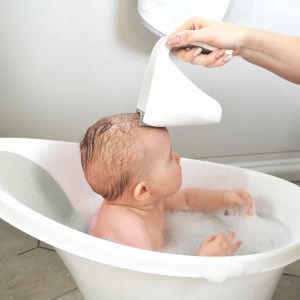 baby in bath with washy cup