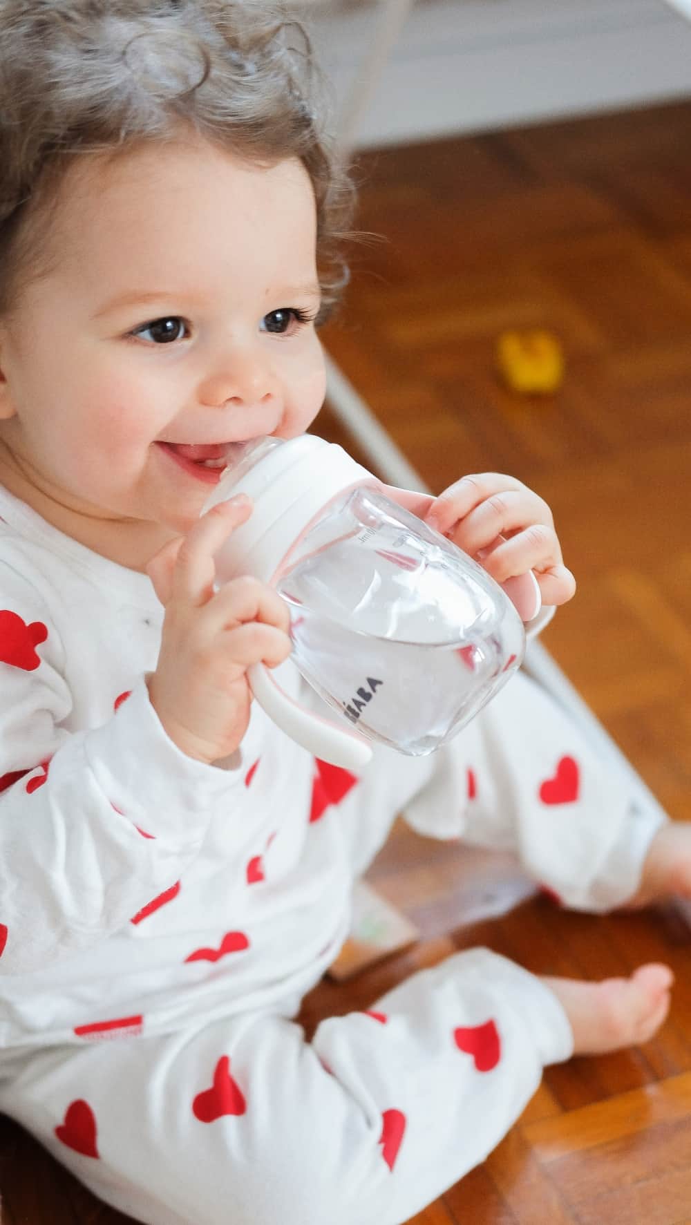 Baby holding BEABA 2-in-1 Training Cup