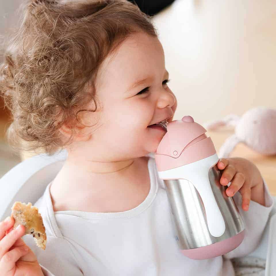 baby holding straw cup