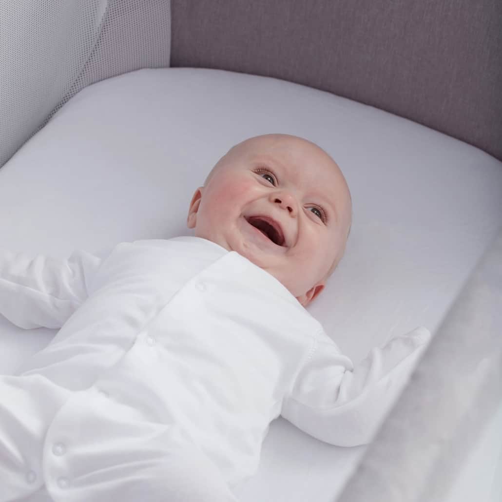 Baby laughing on Shnuggle Full Size Crib Air-Flow Mattress