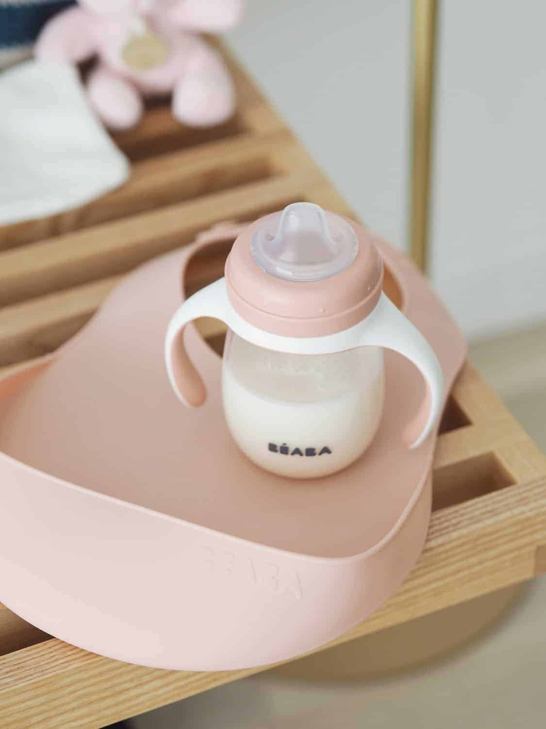 Silicone Bib on Table Next to Sippy Cup