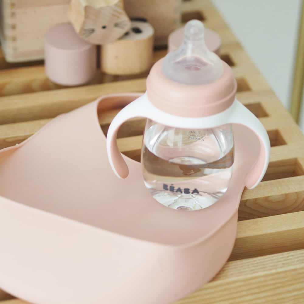 Silicone Bib On Table Next to Sippy Cup