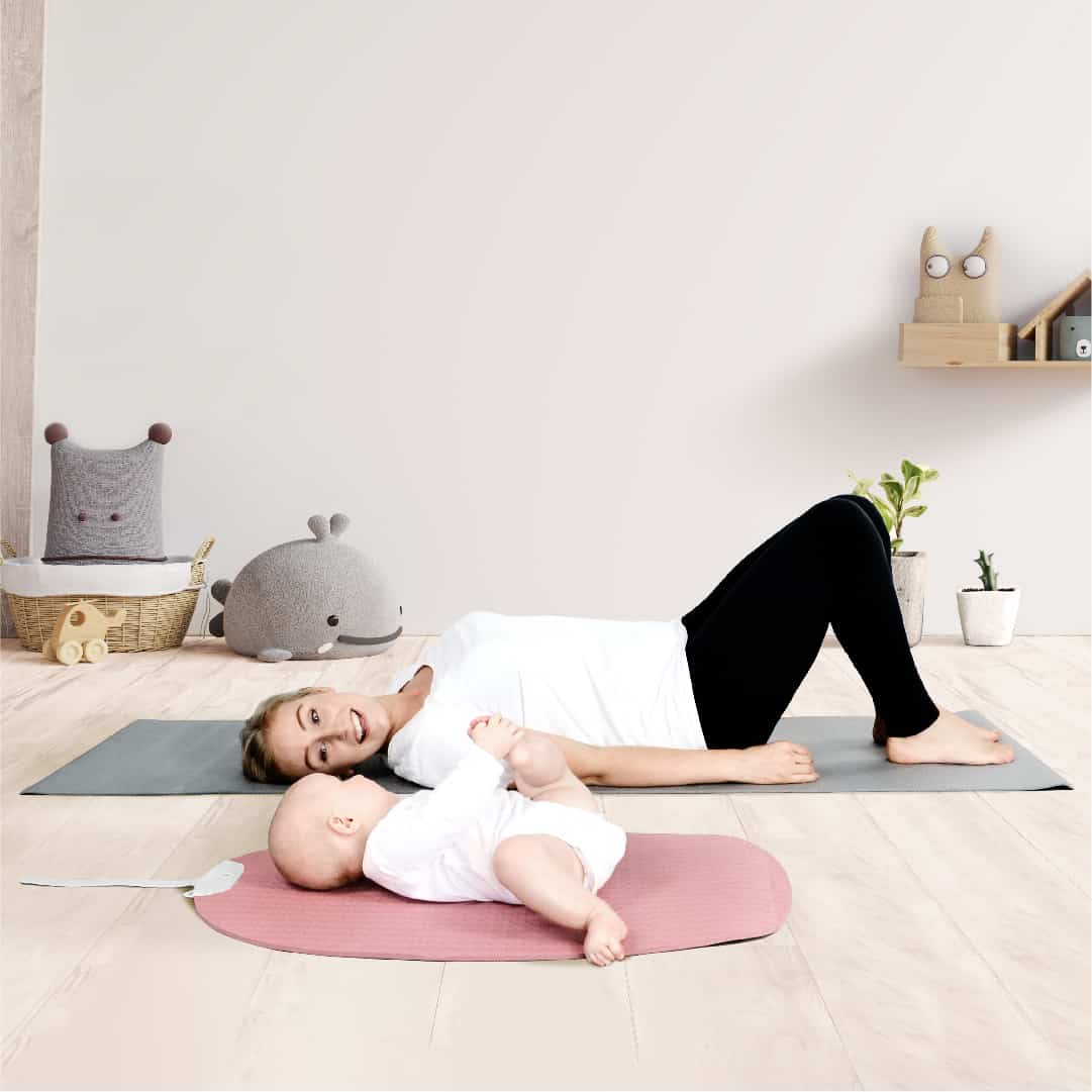 mom and baby on pink shnuggle yoga mat